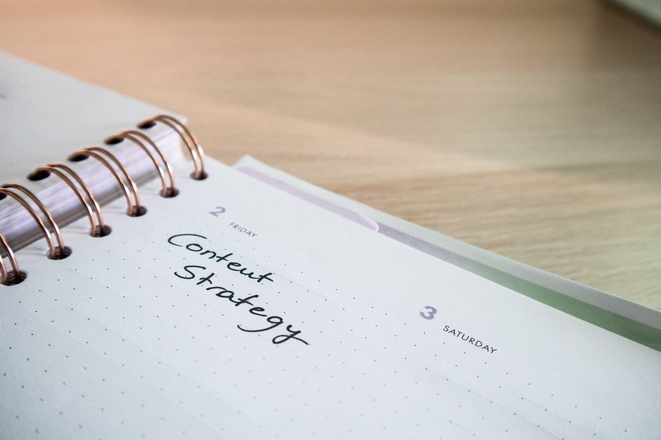 Close-up of a notebook page with 'Content Strategy' written on it, ideal for business planning visuals.